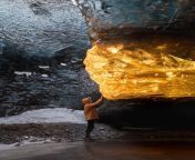 Travel photographer Sarah Bethea captured this breathtaking photo last winter in Iceland of a setting suns golden rays entering an ice cave and turning a section of the caves ice amber. from www cave