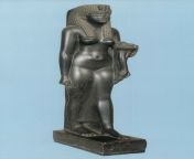 A black basalt sculpture of the queen Cleopatra VII who reigned from 51 to 30 BCE, ending the Ptolemaic Period. She stands in the traditional left-foot-advanced pose, holding a &#39;horn of plenty&#39; (cornucopia) in her left hand and the ankh (life symb from pe ankh