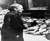 An elderly woman in front of the bodies of school children in Cologne, Germany, after a bombing raid 29-July-1943 from cinema school woman