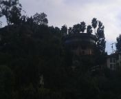 9 years ago while driving up Mt. Helix in LA Mesa, CA. (Sam Diego County). We took a picture of the round house which is rumored to rotate. While checking out the pictures later I noticed what looks to be a ghost in the trees. I googled &#34;Mt Helix Ghos from rituporna ghos