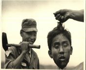 Korean War: South Korean National Police holds the Severed Head of a North Korean communist, Margaret Bourke-White, 1951 from korean bj 혜나