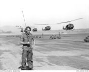 Vietnam War. Phuoc Tuy Province. March 1968. US Army UH-1 Iroquois helicopters swoop in to pick up troops of 3rd Battalion, Royal Australian Regiment (3RAR), from the 1st Australian Task Force (1ATF) Base at Nui Dat. Private Doug Poole maintains radio con from australian teac