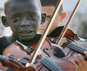 Diego Frazo Torquato, 12 year old Brazilian playing the violin at his teachers funeral. The teacher had helped him escape poverty and violence through music. Sadly Diego died a few years after this was taken due to leukemia. from telugu teacher s