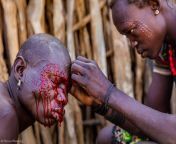 Blood drips down the face of a tribe member during a cultural scarification in Karamoja, Uganda. Photo by Marcus Westberg from baganda pub videos in gulu uganda