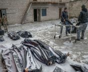 [Graphic] Two men carry a corpse in a body bag to lay it next to others in a snow covered yard in Mykolaiv, a city on the shores of the Black Sea that has been under Russian attack for days on March 11, 2022. (Photo by BULENT KILIC / AFP) from zerrin egeliler bulent kayabas atesli sevisme