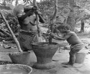 A woman and child pounding cooked palm nuts to make palm oil. Sierra Leone, circa 1973. Palm oil is used in numerous ingredients, including biofuels, fiberboard, soap, cosmetics, and food. from sierra leone porn