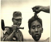 Hand of unseen South Korean holding severed head of North Korean Communist guerrilla by his hair as a member of the South Korean National Police smiles broadly, with an axe over his shoulder. November 17, 1952 / Photograph by Margaret Bourke-White [NSFW]from south korean cup female anchor bj game masturbation
