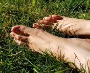 Big feet relaxing in the grass. I sure could use a massage. ?? from indian aunty feet touching in bus