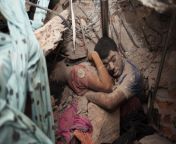 A Final Embrace: The bodies of two workers are uncovered amidst the rubble of the Rana Plaza factory collapse, which crushed to death 1,100 Bangladeshi garment workers making cut-piece clothes for Western brands / Taslima Akhter [NSFW] [56163744] from taslima haq