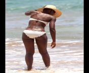 Lupita Nyongo in a white bikini and floppy hat from lupita nyongo nude