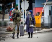A Slovak soldier helps an Ukrainian woman to carry her luggage after after she crossed the border in Vyn Nemeck, eastern Slovakia. [1802 x 1200] from after sch