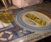 A nice pickle and mustard sandwich and a glass of pickle juice from pickle