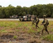 3 November 2021. Soldiers from 1st Battalion, Royal Australian Regiment (1RAR), and M1A1 AIM Abrams tanks from the 2nd Cavalry Regiment (2 CAV), Royal Australian Armoured Corps (RAAC), patrol through Cowley Beach Training Area, Queensland, during a combin from australian seafoods