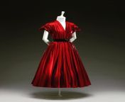 Red hot silk, cinched with a slash of black at the waist. One of Diors early collections, the 1947 Aladdin dress. from red hot silk