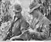 Phuoc Tuy Province. 1967. A quick map check by Corporal Daryle Poke (left), and Sergeant Bob Armitage, both of Delta (D) Company, 5th Battalion, Royal Australian Regiment (5RAR). They lead a reconnaissance patrol through jungle near the 1st Australian Tas from b d company p