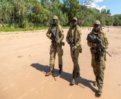 Australia. July 2022. North-West Mobile Force (NORFORCE) Darwin Squadron soldiers, Private Peter Puruntatameri, left, Private Blake Carter and Private Misman Kris on a beach on Melville Island during a community engagement visit to the Tiwi Islands. (1200 from private pornleina