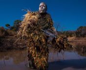 Petronella Chigumbura, a member of the Akashingaa nonprofit, all-female anti-poaching unitpractices reconnaissance techniques in the Zimbabwean bush. (Nat. Geo.2019 *Photo by Brent Stirton*) from dual survival ilhados nat geo