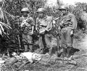 Private John Gavenas, of Shenandoah, PA, (center) with two Chinese-American members of General Merrill&#39;s infantrymen, look at the body of a slain Japanese soldier. from vagina of amisha pa