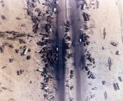 Aerial view of the Highway of Death, the result of American forces bombing retreating Iraqi forces, Kuwait, 1991 from american rainy highway drive