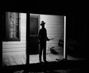 &#34;The Rev. Joe Carter, expecting a visit from the Ku Klux Klan after he dared to register to vote, stood guard on his front porch. West Feliciana Parish, Louisiana. 1964.&#34; from parish blair