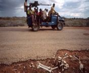 SOMALIA. 1992. A &#39;technical&#39; armed truck passes the remains of a corpse by the road. Photograph: Chris Steele-Perkins/Magnum Photos from wasmo siilka somalia