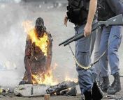 A victim of necklacing originally used to punish black collaborators who worked with the apartheid government of South Africa - this man was subject to a xenophobic attack in Ramaphosa (May 18 2008) from black south africa