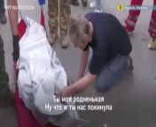 A man on his knees cries for his dead wife. His son cannot tear his father away from his dead mothers body. The woman went out to feed the cats in her yard in Kharkiv when she was hit. from boy his mother web is father away